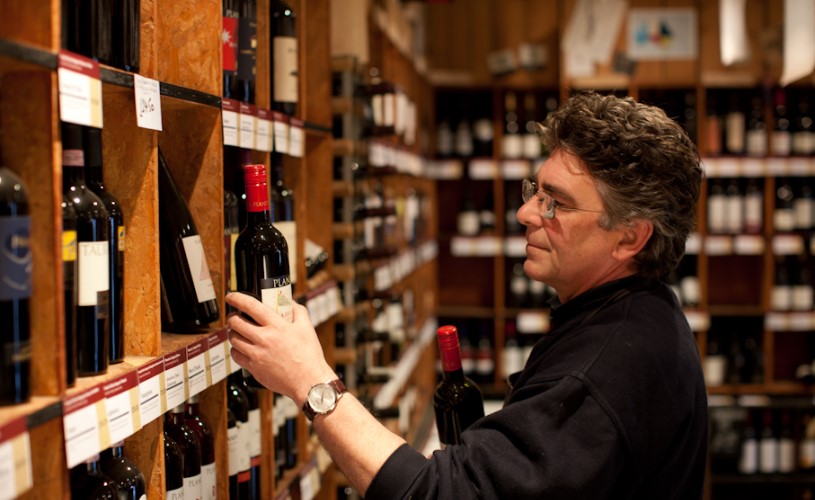 man browsing wine shelves